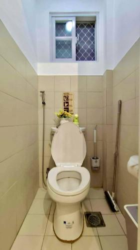 a bathroom with a white toilet with a window at Casa Esperanza 1376 in Dauis