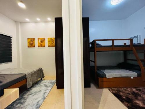 a room with two bunk beds and a hallway at Casa Esperanza 1376 in Dauis