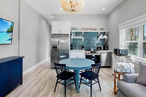 a kitchen and dining room with a blue table and chairs at Villa #3 Seahorse in Holmes Beach