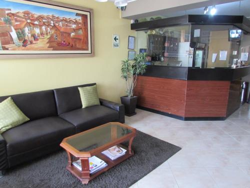 a living room with a couch and a coffee table at Hotel Bohemia in Lima