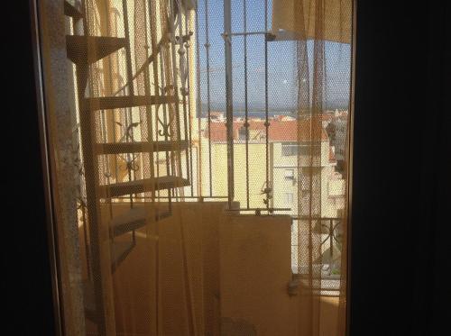 an open window with a view of a building at B&B Su Canistreddu in Alghero