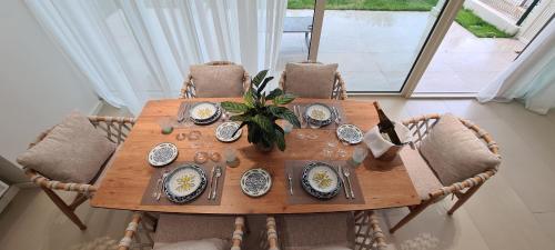 a wooden table with dishes on it in a room at TIS, Green Coast in Palasë
