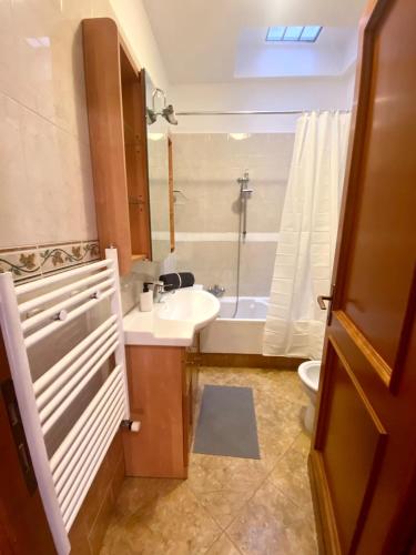 a bathroom with a sink and a tub and a toilet at Domus Ciampino 4 bedrooms apartment in Ciampino