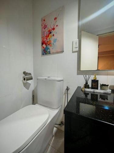 a bathroom with a white toilet and a sink at Maritime Suite by Ocean Luxe 2BR Seaview Dryer Water Dispenser in George Town