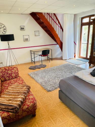 a bedroom with a bed and a couch and a desk at Troisdorf - City - EG - 145 Qm - bis 7 Schlafplätze in Troisdorf