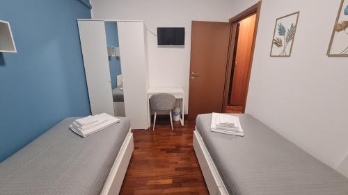 two twin beds in a room with a mirror at Casa Gavazzeni Il Sogno in Bergamo