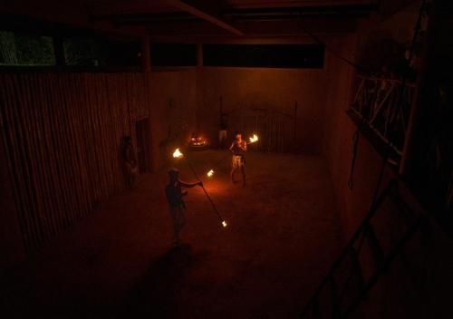 two people are standing in a dark room with torches at Jeevess Retreat Wayanad in Wayanad
