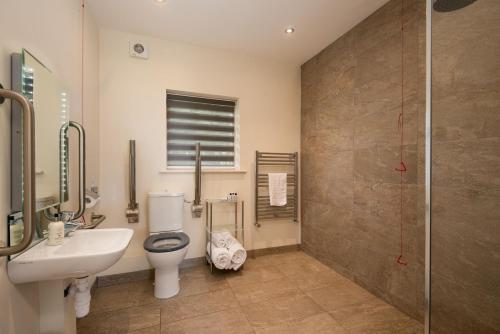 a bathroom with a toilet and a sink and a shower at Vesta View in Hexham