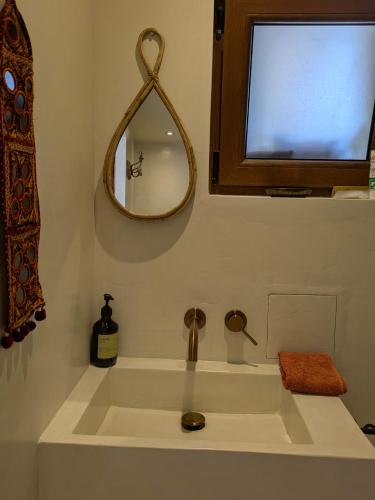 a bathroom with a sink and a mirror at Le Daou Sormiou in Marseille