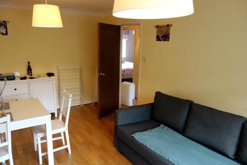 a living room with a couch and a table at NEW Cosy 2 Bedroom Flat - Englefield Green in Englefield Green