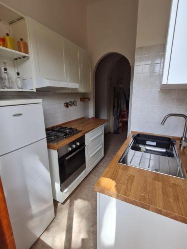 a kitchen with a sink and a stove top oven at Casa Notteri 2 in Notteri