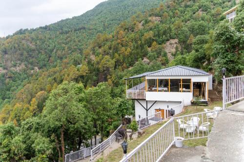 a house on the side of a mountain at Ila by Aaryam, Kanatal in Chamba