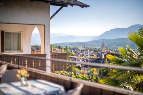 a balcony with a view of a city at Pension Latemar in Caldaro