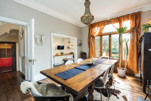 a dining room with a wooden table and chairs at Beautiful 3BD Home Forest Hill South London in London