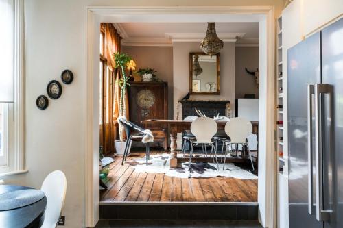 a kitchen and dining room with a table and chairs at Beautiful 3BD Home Forest Hill South London in London