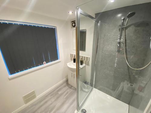 a bathroom with a shower with a glass shower stall at Victoria Homes in Stoke on Trent