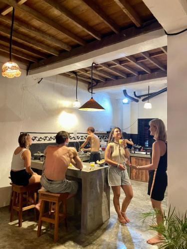 a group of people in a kitchen preparing food at Sun & Surf Hostel - STARLINK in Santa Monica