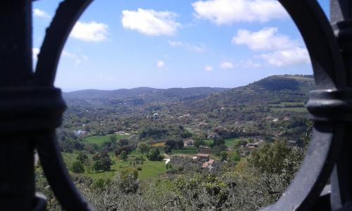 a view of a valley through a round window at La Maison Galu' in Itri