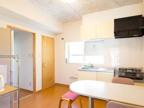 a kitchen with a table and chairs in a room at Sun Green Resort Hotel Ishigaki in Ishigaki Island