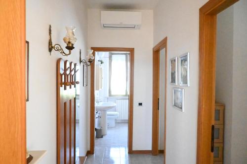 a hallway with a bathroom with a toilet and a sink at PP06 - Porto Potenza, trilocale con aria condizionata vicino al mare in Porto Potenza Picena