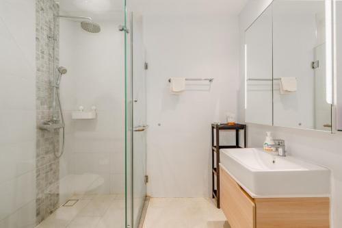 a white bathroom with a sink and a shower at C176 Diamond Paradise Getaway Condo Phuket in Bang Tao Beach