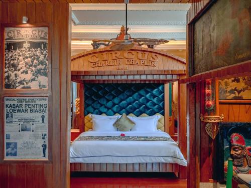 a bedroom with a large bed in a room at House of Tugu, Old Town Jakarta in Jakarta