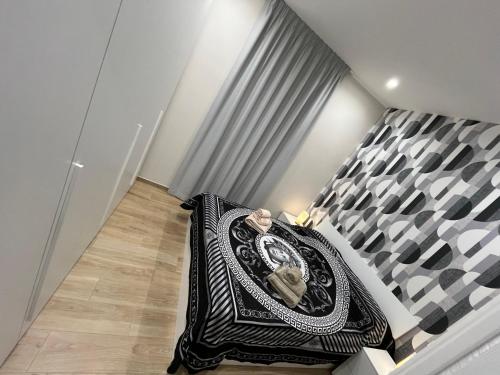 a bedroom with a bed with a black and white at A due passi dal mare in Barletta