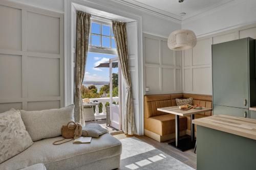 a living room with a couch and a table at Vomero Holiday Apartments in Torquay