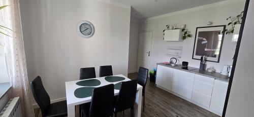 a kitchen and dining room with a table and chairs at Gościniec Husarski in Sandomierz
