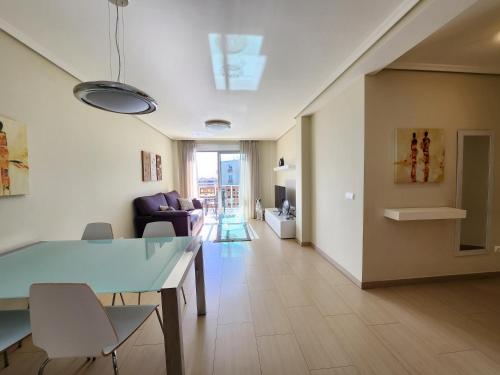 a living room with a table and chairs at Spacious 2 Bedroom Flat in Playa de la Tejita in La Tejita