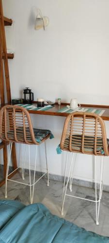 a table and two chairs in a room at Παραθαλασσιο στουντιο Μιχαλιας Sea view studio Michalias Νουμερο 8 in Agia Marina Aegina
