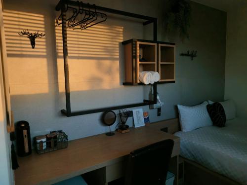 a room with a desk with a bed and a mirror at 濱境行旅 Begin Inn in Xiaoliuqiu
