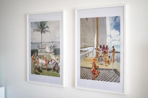 two framed photographs of people on a sail boat at Xanadu Resort in Gold Coast