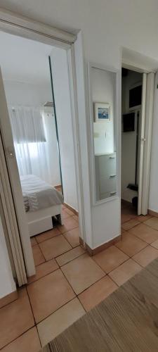 a room with a bedroom with a bed and a mirror at House Feniks, 2 bedrooms, private parking, Starlink! in Milna