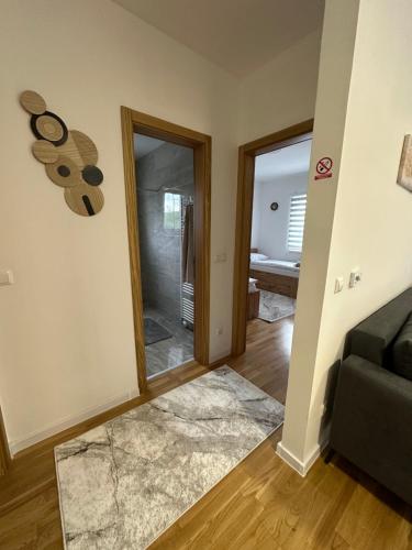a living room with a couch and a mirror at ZORA apartmani Sarajevo in Sarajevo