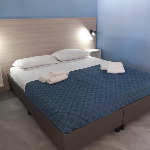 a bedroom with a bed with two towels on it at Funny Village Dog Friendly in Pizzo