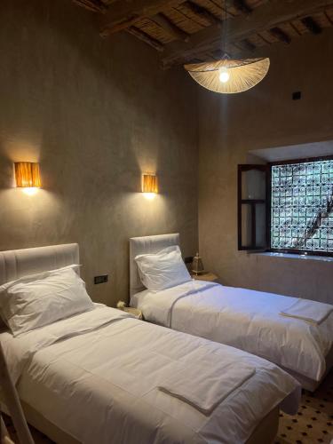 a bedroom with two beds and a window at Ranch Skouraya in Tajante