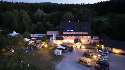 an aerial view of a hotel with cars parked in a parking lot at Landhaus Obere Säge in Schömberg