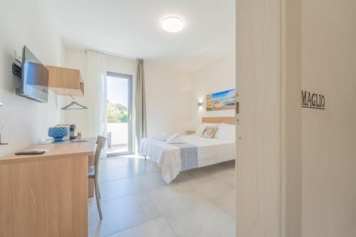 a bedroom with a bed and a desk in a room at Calafato Guest House in Favignana