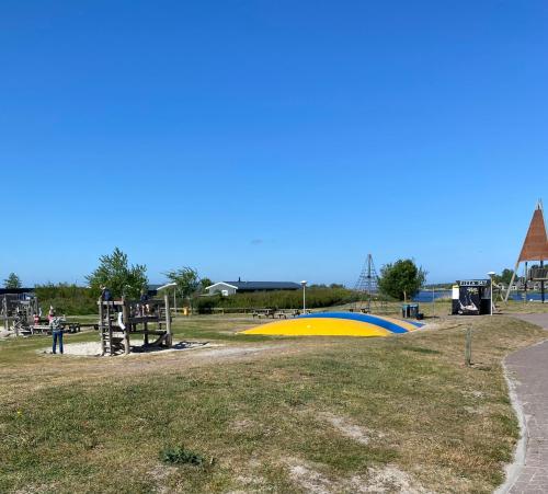 a park with a playground and a play structure at 4 persoons chalet HZ 01 in Lauwersoog