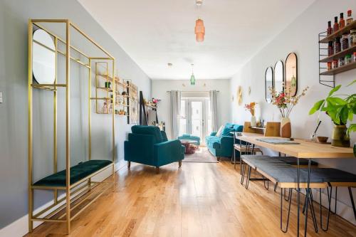 a living room with blue chairs and a table at Lovely Harbourside Apartment with Free Parking in Bristol