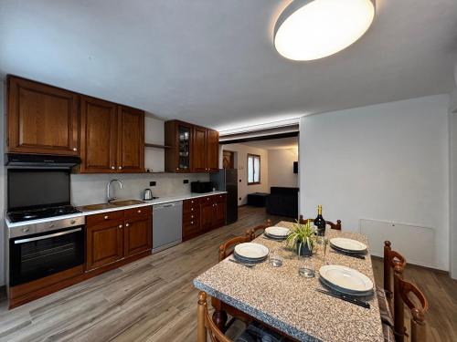 a kitchen with a table with chairs and a dining room at Casa Mariett Gravedona - Larihome A92 in Gravedona