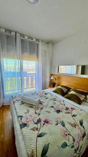 a bedroom with a large bed with a floral bedspread at House Samaniego 12 in Madrid