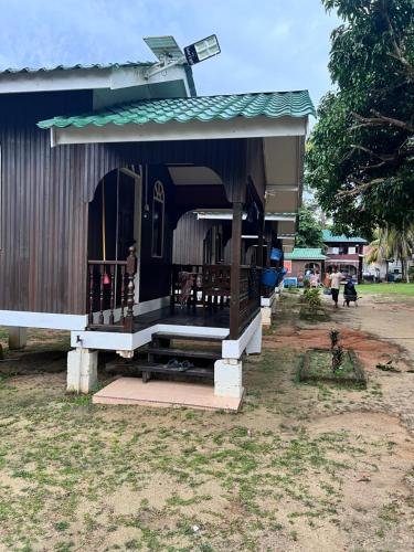 a small building with a porch and a cross on top at Mama's Chalet Pulau Perhentian Besar in Perhentian Island