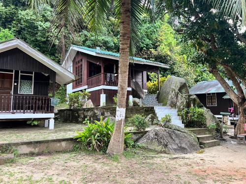 a house with a tree in front of it at Mama's Chalet Pulau Perhentian Besar in Perhentian Island
