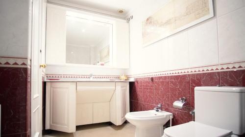 a bathroom with a toilet and a sink and a mirror at Villa Nuria by HR COSTABRAVA in Platja d'Aro