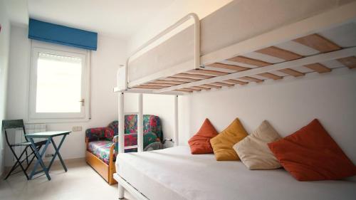 a bedroom with a bunk bed and a chair at Villa Nuria by HR COSTABRAVA in Platja d'Aro