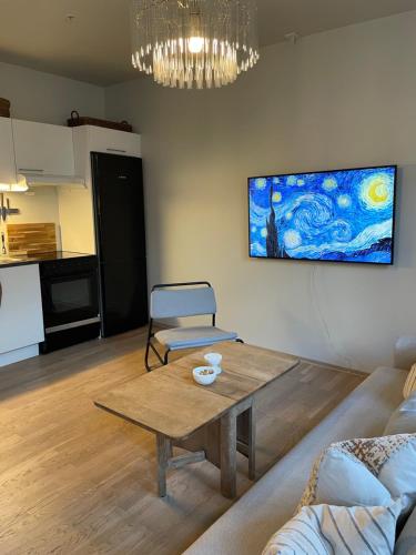 a living room with a table and a couch at Central apt near beach and city life in Kristiansand