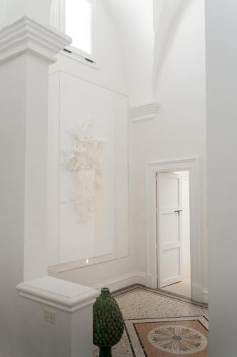 a room with white walls and a vase on the floor at Palazzo Maritati in Nardò