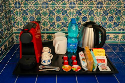a black tray with food and a tea kettle at Suite Palazzo Capri - Seaview in Capri